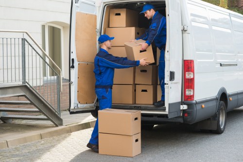 Removal team loading household items into a van