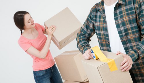 Trained movers handling belongings with care and correct lifting methods