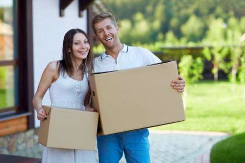 Local movers carrying furniture through a Kingston apartment building