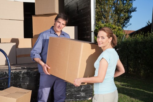 Staff assessing risk and planning safe lifting during a removals job